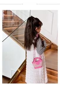 Detailed side view of pink plaid mini handbag for girls with adjustable strap