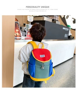 Detail showing back view of colorful school bag for children on a model in a cafe