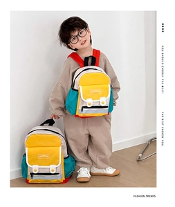 Detail view of colorful kids backpack with front pocket and reflective safety stripe