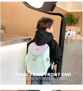 Detail of mint green and purple kids backpack with drawstring closure and metal buckle