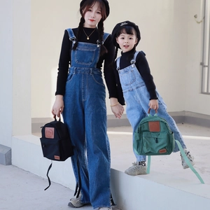Parent-child denim overalls with dark blue canvas backpack featuring a smile patch