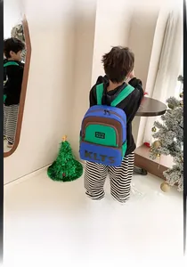 Detail of adjustable green padded shoulder straps and durable canvas material on kids backpack