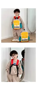 Close-up of contrast color schoolbag featuring wide red straps and yellow canvas