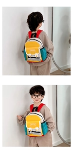Detail view of colorful patchwork kid backpack with durable shoulder straps and side pockets