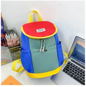 Detail of multi-color block canvas backpack with dual zippers and side pockets for kids
