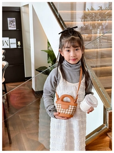 Classic brown plaid mini crossbody bag for kids with leather trim shown in a modern interior