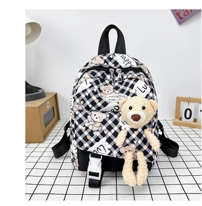 Détail d'un sac à dos enfant à carreaux avec imprimés ours et peluche décorative