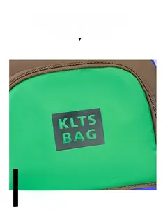 Detail shot of the green and brown canvas backpack showing the KLTS BAG logo patch