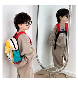 Detail of colorful canvas kids backpack showing safety chest buckle and side mesh pockets