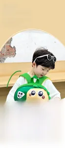 Detail of green 3D dinosaur backpack for toddlers showing wide straps and shell shape