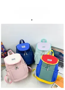 Close-up of four colorful multi-color patchwork backpacks with FASHION label and side drawstrings