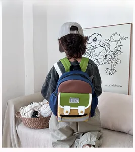 Detail view of colorful patchwork kid backpack with broad adjustable shoulder straps