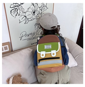 Detail of colorful patchwork kids backpack with FASHION label and zip pocket