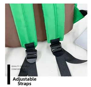 Detail of adjustable green nylon shoulder straps with black buckles on a kids backpack