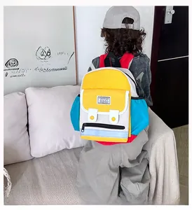 Detail of colorful patchwork canvas backpack for kids featuring bold fashion label