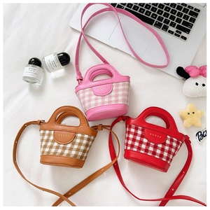 Detailed view of mini plaid bucket bags in pink, brown, and red with leather trim