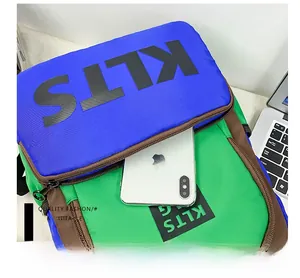 Detailed close-up of the front zipper pocket on a color-block canvas kids' backpack