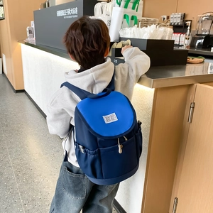 Kids casual blue backpack with drawstring design and side pockets for outdoor travel