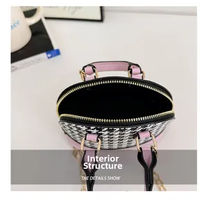 Internal structure of mini shell handbag showing houndstooth fabric and gold chain strap
