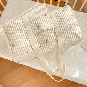 Quilted cream mommy bag with pink tulip embroidery and spacious interior for travel