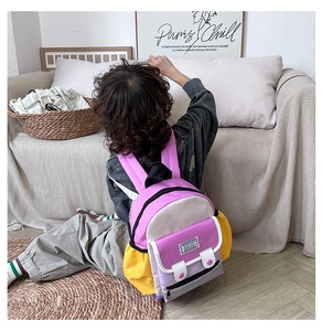 Detailed back view of colorful school backpack featuring purple and pink contrast colors