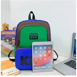 Detail view of colorful tri-tone kids backpack with letters and double pockets