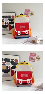 Detail of colorful canvas kids backpack with buckle flap and fashion bag emblem