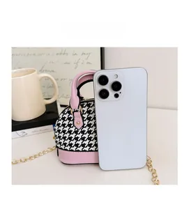 Mini shell-shaped crossbody bag with pink leather and houndstooth pattern detail