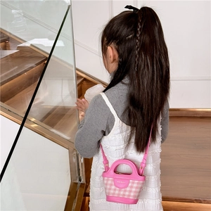 Girl's mini pink plaid tote bag with leather handles and crossbody strap on model
