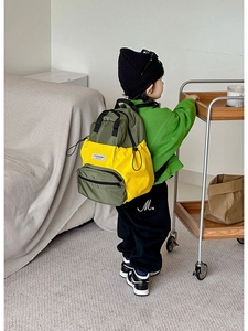 Détail d'un sac à dos léger vert et jaune pour enfants en tissu nylon imperméable
