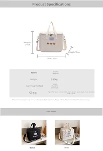 Detailed view of embroidered bear mommy bag with size labels 32x24x19cm and detachable strap