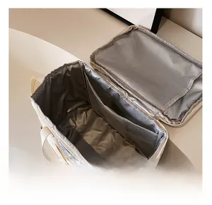 Detailed interior view of insulated baby bottle bag with mesh pocket and zipper