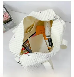 Spacious main compartment of white quilted mother bag with cute floral embroidery
