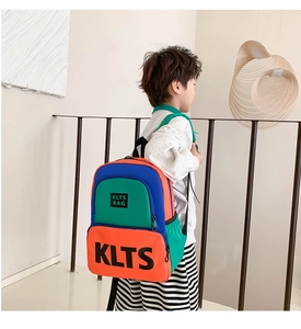Detail of colorful kids backpack with adjustable straps worn by a young boy