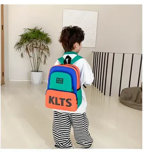Detailed view of child wearing a color-block backpack with vibrant blue and orange hues