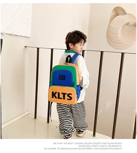 Detail of color-block kids backpack with KLTS lettering on breathable mesh side pocket