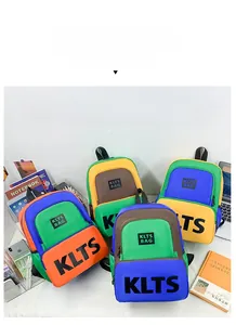 Detail view of four contrast-color canvas schoolbags with KLTS letter logo and trendy design