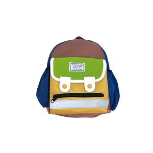 Colorful canvas backpack for kids with letter patch and velcro pocket in flat lay view