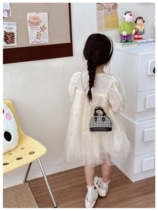 Toddler girl wearing vintage houndstooth shell crossbody bag with a gold chain strap