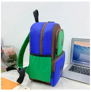 Detail of color-block backpack with blue and green panels showing large capacity main storage
