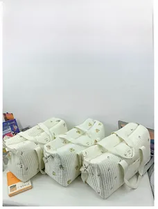 Detailed quilted texture of cotton travel bags with bear and tulip floral prints