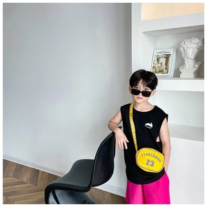 Close-up of yellow nylon crossbody bag with STARSBRUG 23 lettering and black sunglasses