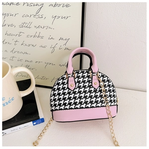 Detail of mini shell bag with houndstooth pattern and pink leather contrast handles