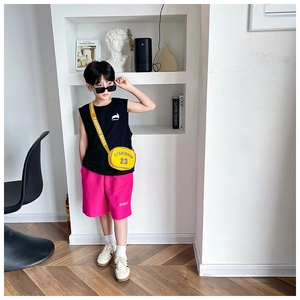 Close-up of a trendy yellow crossbody bag with letter print for kid's fashion outfit