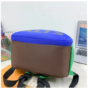 Detail of color-block kids backpack with XLTS lettering on blue, brown and green fabric