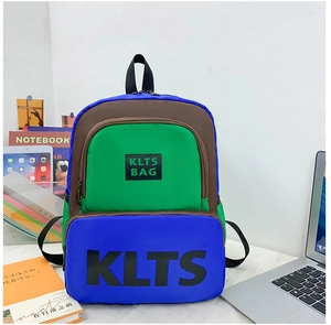 Detail of color-block backpack for kids featuring bold blue and green fabric with KLTS logo