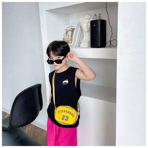 Detail of a bright yellow kids nylon crossbody bag with purple lettering and a printed strap