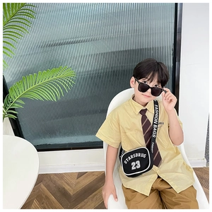 Kids black nylon crossbody bag featuring white logo text and adjustable fashion strap