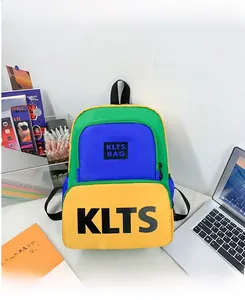 Detail of colorful three-tone patchwork backpack for boys featuring KLTS lettering print