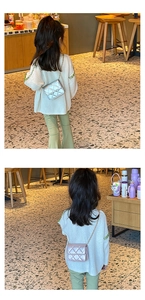 Rear view of child wearing silver and pink quilted mini flap bags with metal chain